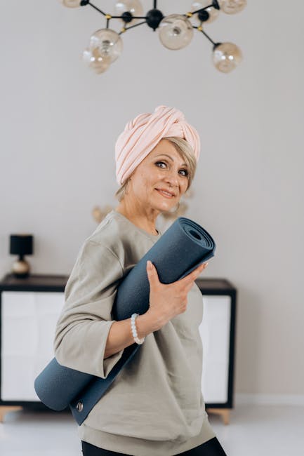 Smiling person in comfortable clothes stretching on a yoga mat at home